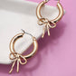 WORN GOLD BOW PUFFY HOOP EARRINGS